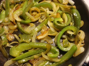 Olive oil, onion and peppers add to my sorta Mexican veggie wraps on Taco Tuesdays