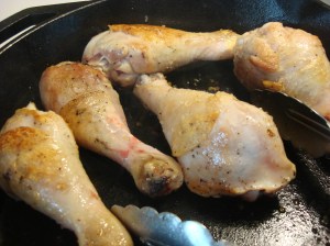 Browning the drumsticks in a cast iron skillet